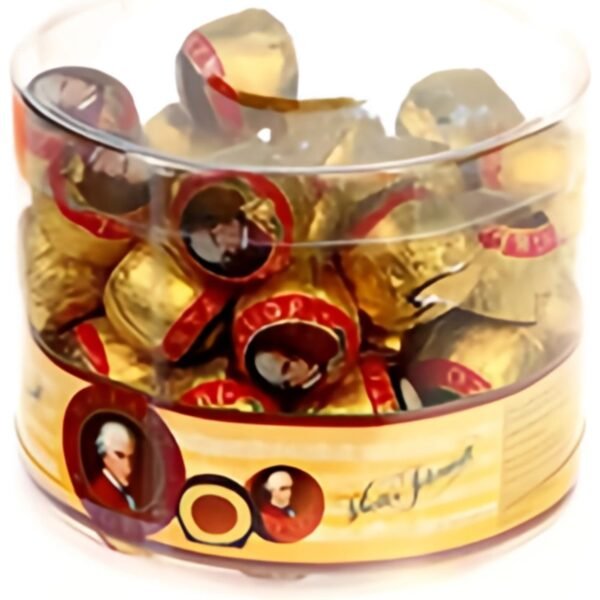 A delicious collection of iconic Mozart Balls, featuring a smooth pistachio and nougat filling, coated in milk chocolate and wrapped in a colorful foil.